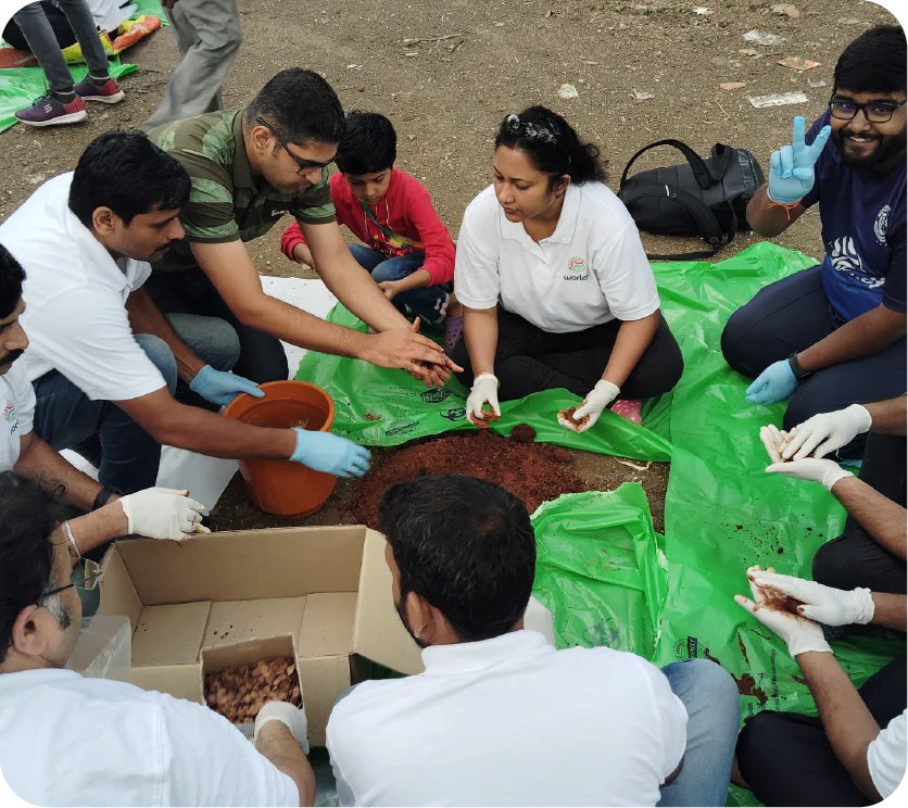Children and volunteers posing during a seedball awareness activity